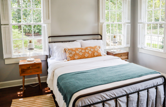Hero image showing a professionally styled short-term rental property with clean, modern interiors, paired with promotional messaging about increasing bookings through short-term rental management services.