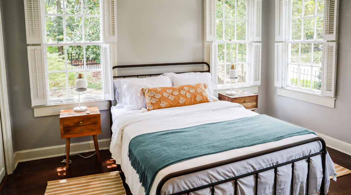 Hero image showing a professionally styled short-term rental property with clean, modern interiors, paired with promotional messaging about increasing bookings through short-term rental management services.