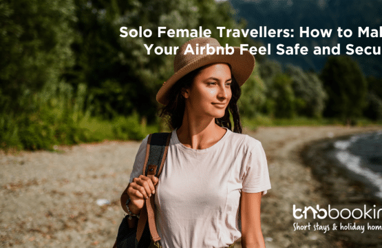 Confident solo female traveller unlocking an Airbnb apartment door with luggage in hand.