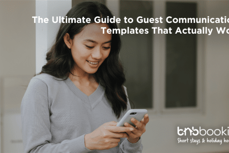 Airbnb host using a laptop to send automated welcome messages to guests before check-in.