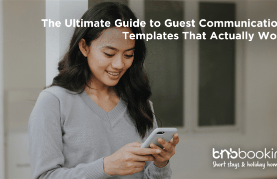 Airbnb host using a laptop to send automated welcome messages to guests before check-in.